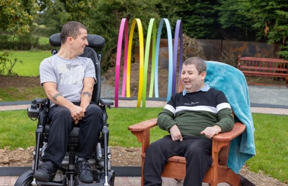 Two men chatting in a garden