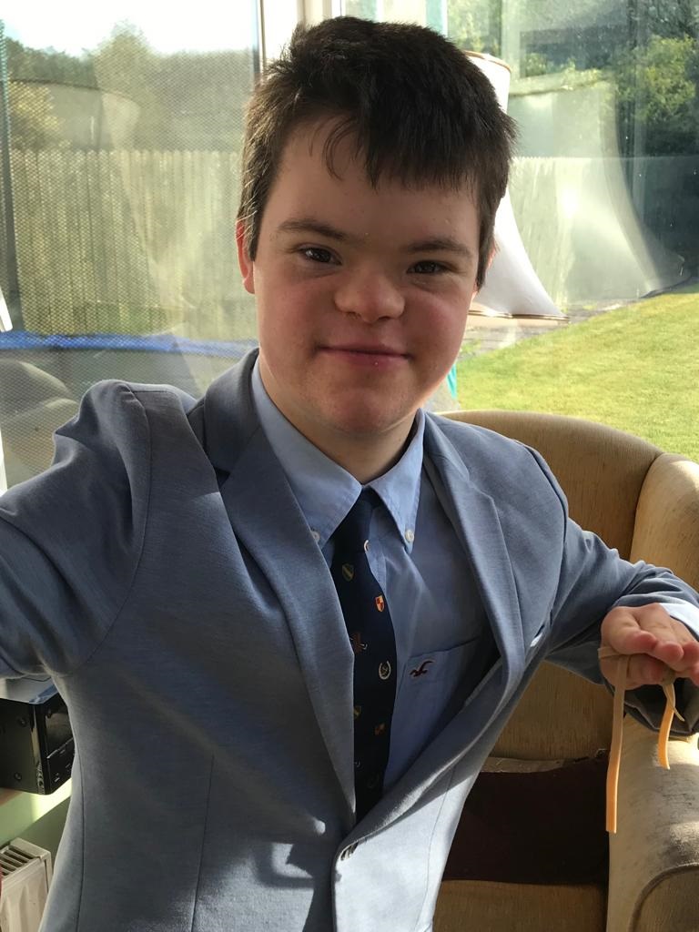 Young man smiles for camera in suit and tie