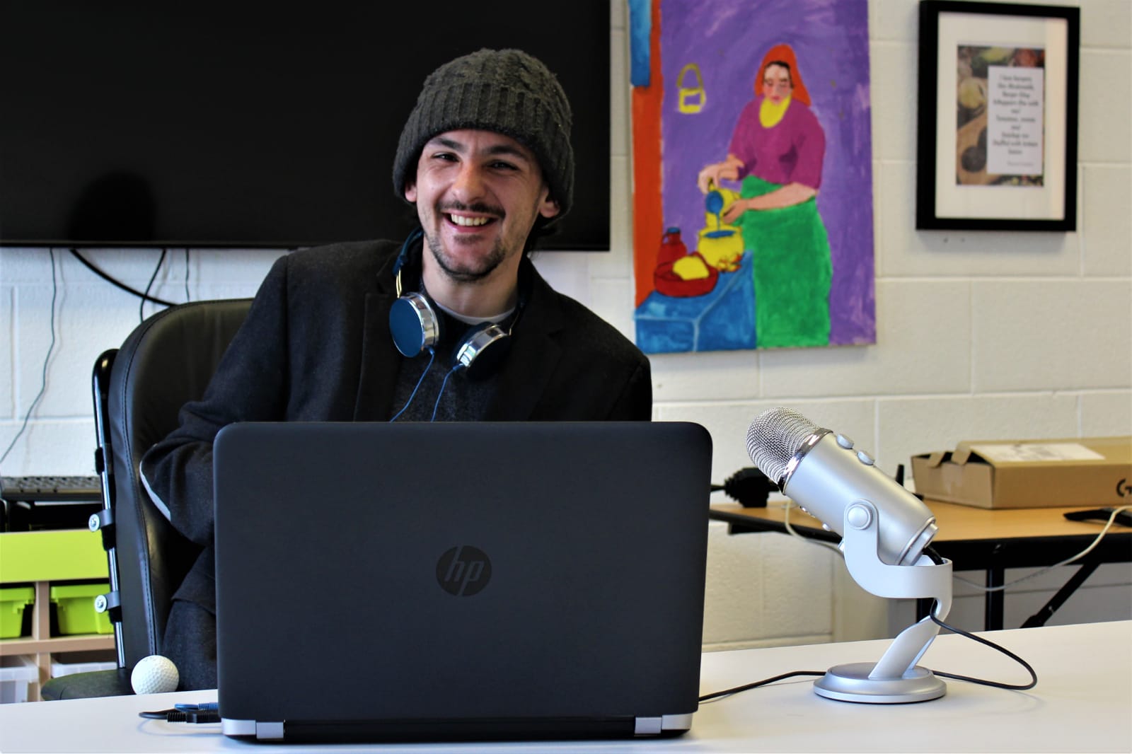 Young manwith headphones in front of laptop