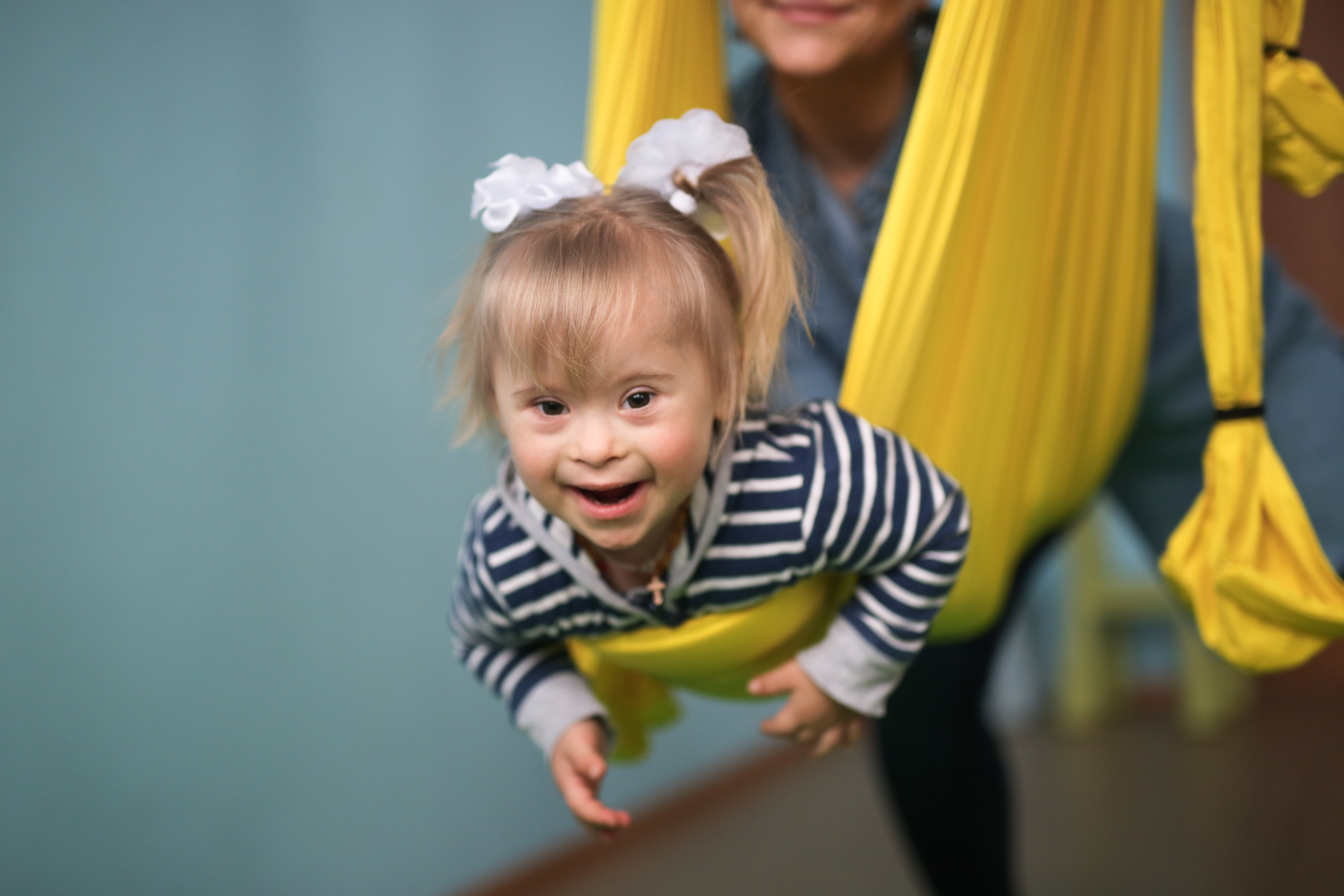 Smiling girl in a yellow swing