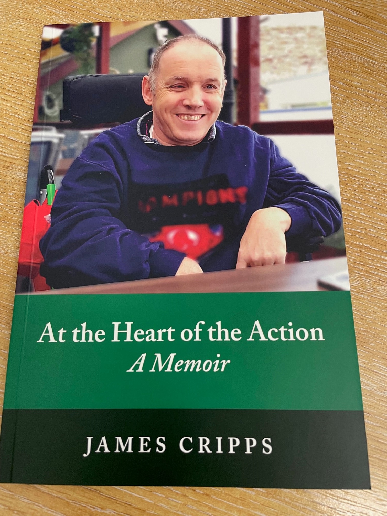 Front cover of book featuring photo of James Cripps and book title 'At the Heart of the Action: A Memoir'