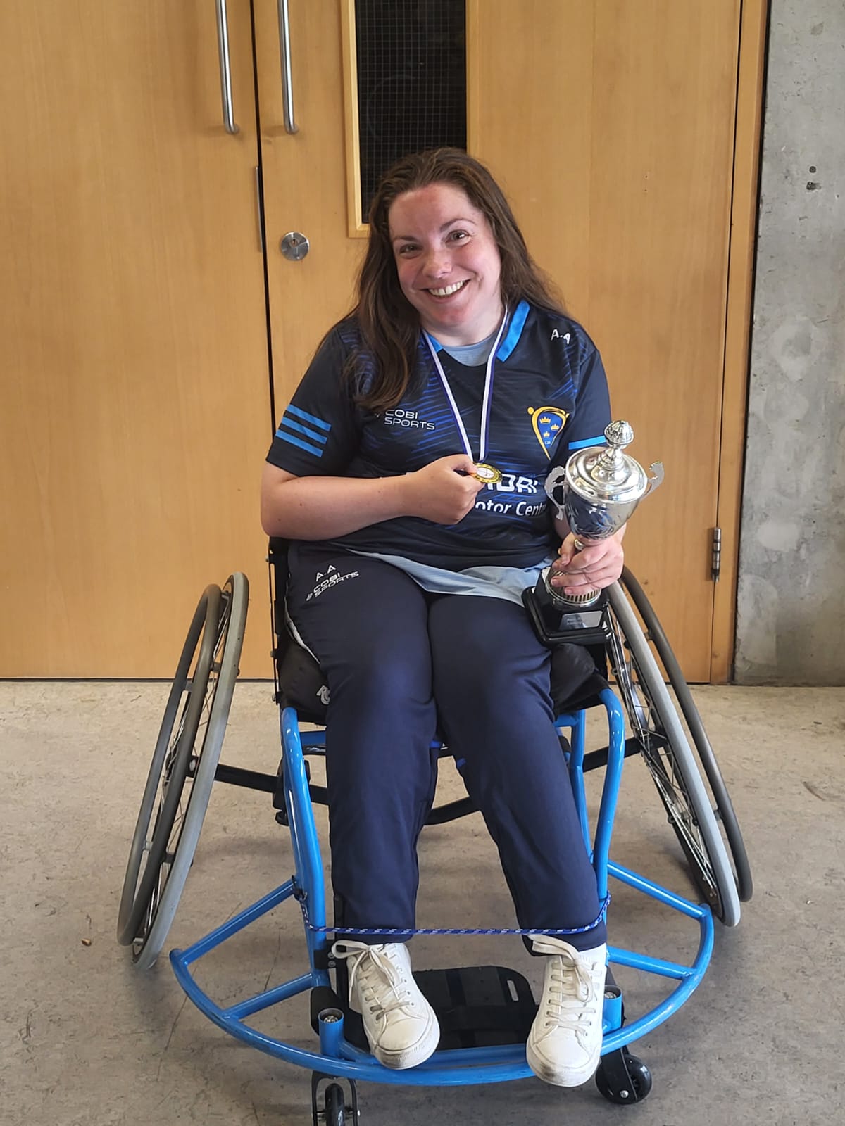 A photo of a young woman holding a trophy