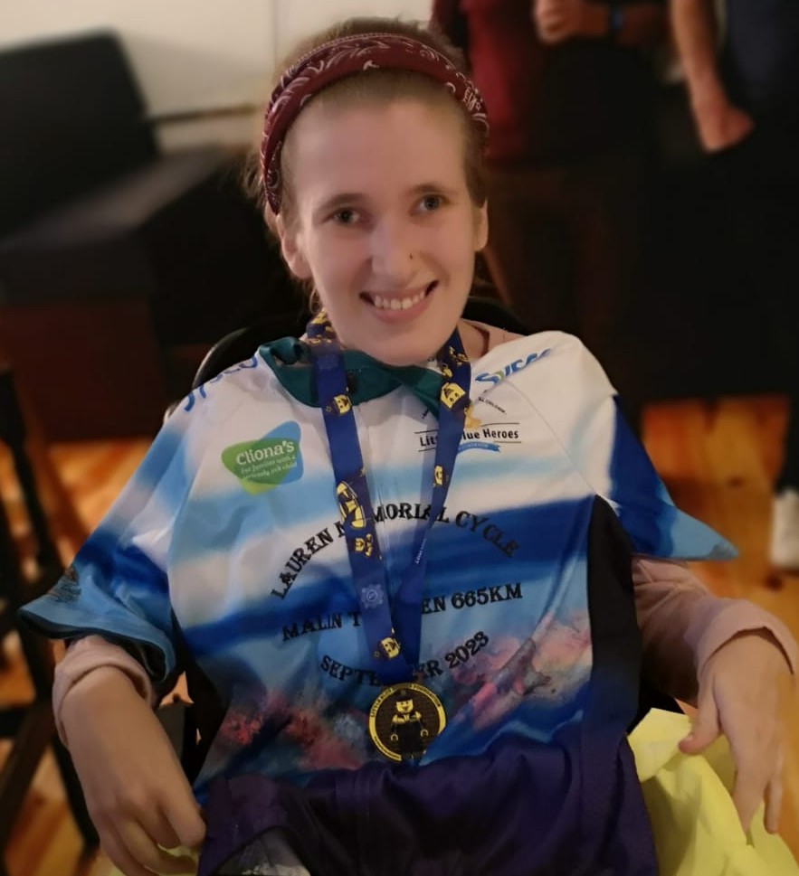 Life With No Limits Champion Sarah O’Sullivan wearing a commemorative cycling jersey and medal after completing a long-distance charity cycle challenge.