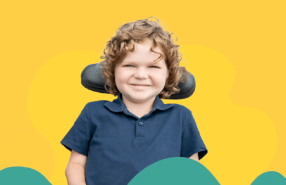 Smiling boy who is a wheelchair users