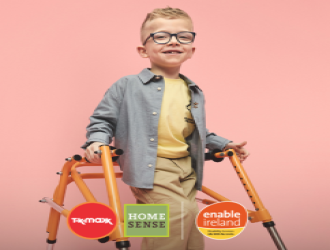 Young boy using a walker and smiling at camera 
