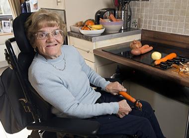 woman in kitchen peeling carrots