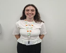 Woman with long hear and wearing a white shirt